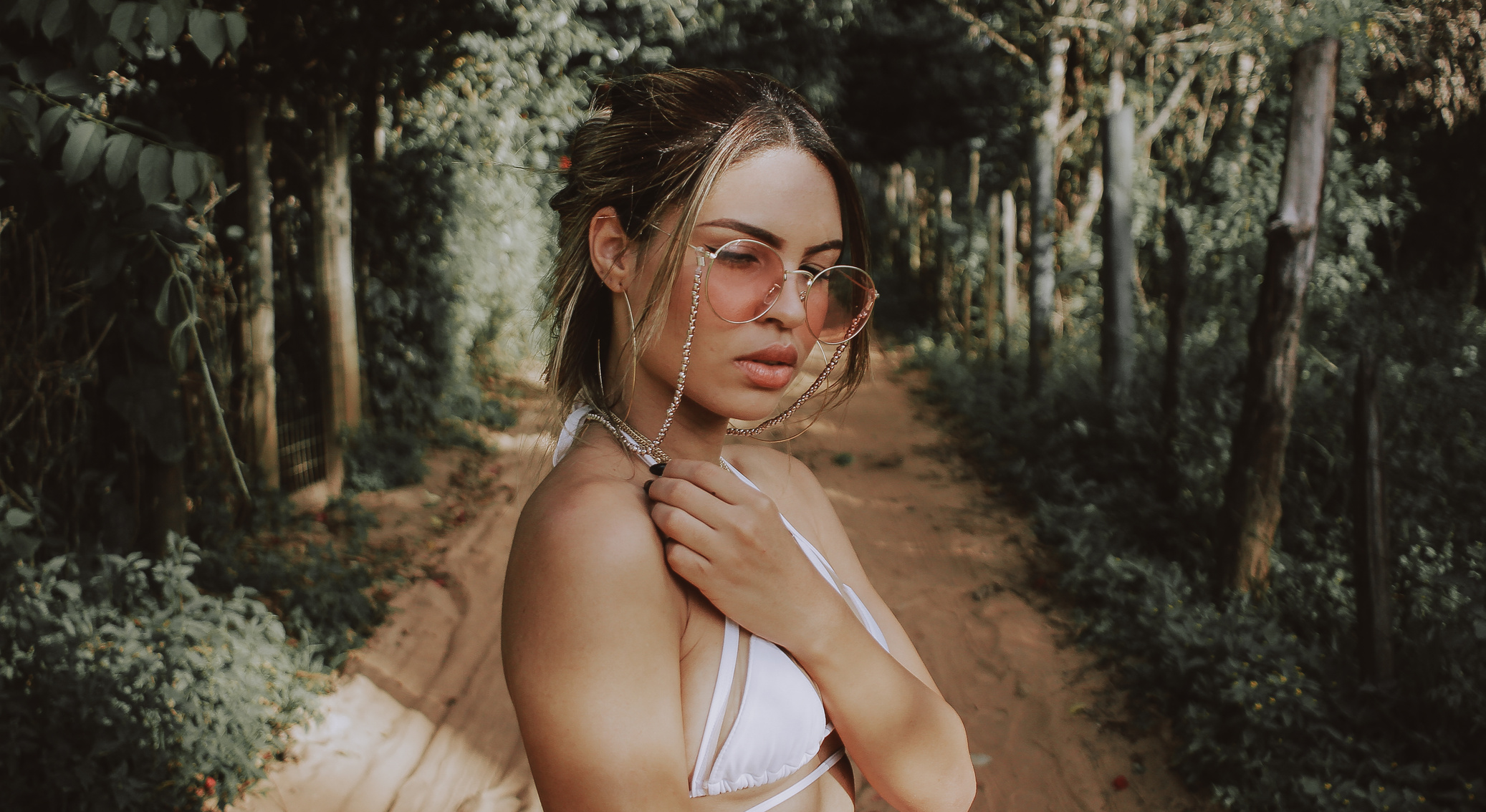 Woman Wearing White Brassiere and Gold-colored Frame Sunglasses Between Forest